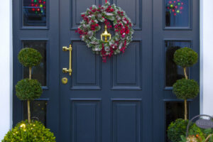 historical wooden front door decorated with garland